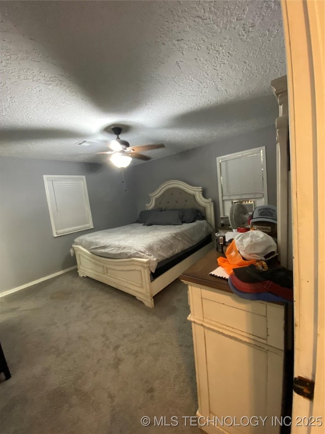 carpeted bedroom with a textured ceiling and ceiling fan