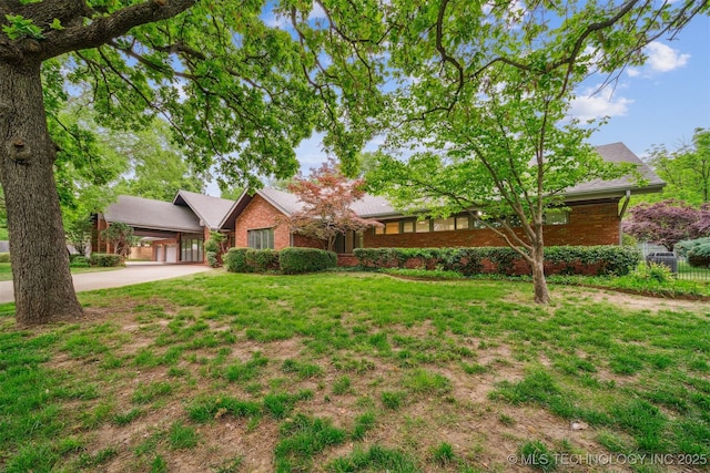 3219 S Birmingham Ave, Tulsa, OK 74105 - ranch-style house featuring driveway and brick siding