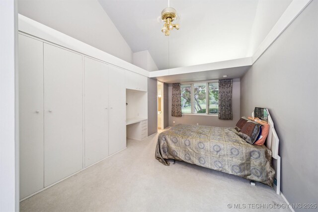 3219 S Birmingham Ave, Tulsa, OK 74105 - carpeted bedroom with vaulted ceiling and a closet