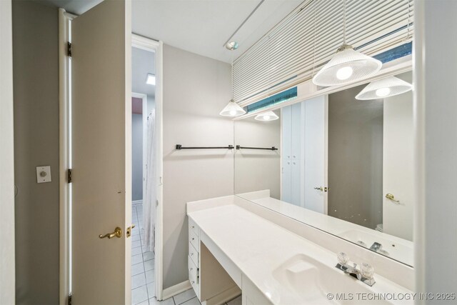3219 S Birmingham Ave, Tulsa, OK 74105 - bathroom featuring tile patterned flooring, vanity, and baseboards