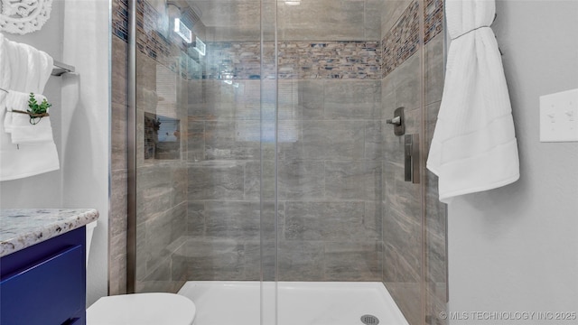 711 N SW, Ardmore, OK 73401 - bathroom with a stall shower, toilet, and vanity