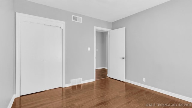 711 N SW, Ardmore, OK 73401 - unfurnished bedroom featuring wood finished floors and baseboards