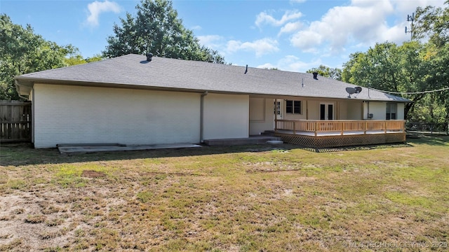 711 N SW, Ardmore, OK 73401 - back of property featuring a deck and roof with shingles