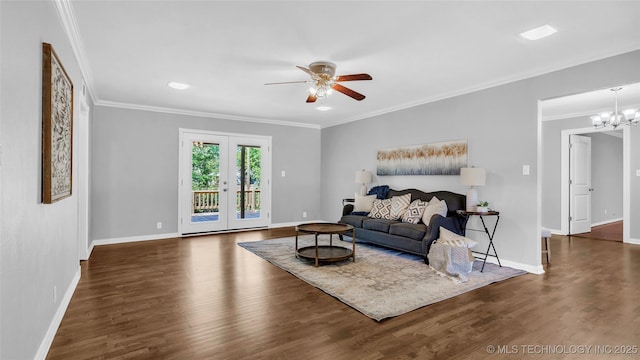 711 N SW, Ardmore, OK 73401 - living area with ceiling fan, crown molding, baseboards, wood finished floors, and a chandelier