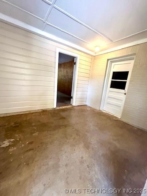 711 N SW, Ardmore, OK 73401 - unfurnished room featuring concrete flooring and wood walls