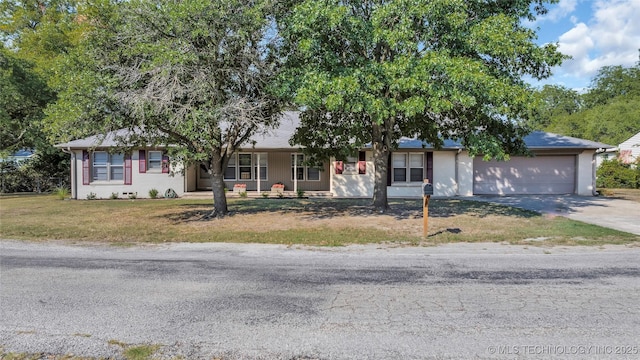 711 N SW, Ardmore, OK 73401 - ranch-style home with concrete driveway, an attached garage, and a front yard