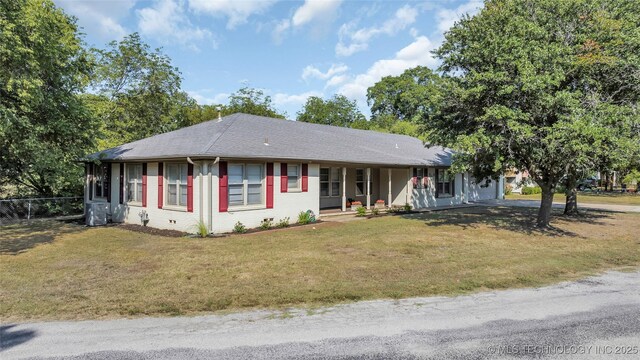 711 N SW, Ardmore, OK 73401 - ranch-style home featuring covered porch, cooling unit, and a shingled roof