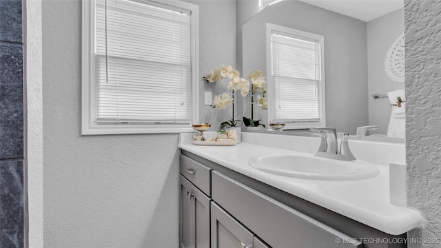 711 N SW, Ardmore, OK 73401 - bathroom featuring a textured wall and vanity