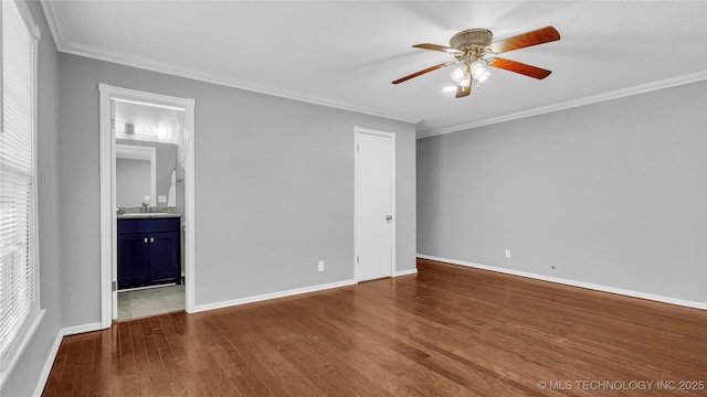 711 N SW, Ardmore, OK 73401 - unfurnished bedroom featuring crown molding, dark wood finished floors, baseboards, and ensuite bathroom