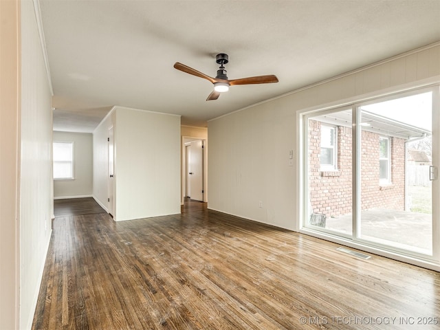 spare room with wood finished floors and a ceiling fan