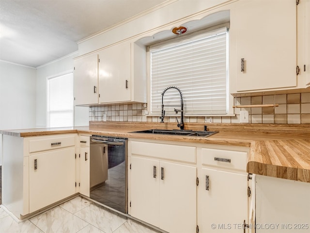 kitchen with stainless steel dishwasher, a sink, ornamental molding, backsplash, and light marble finish flooring