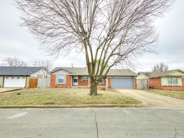 ranch-style home featuring brick siding, driveway, and an attached garage