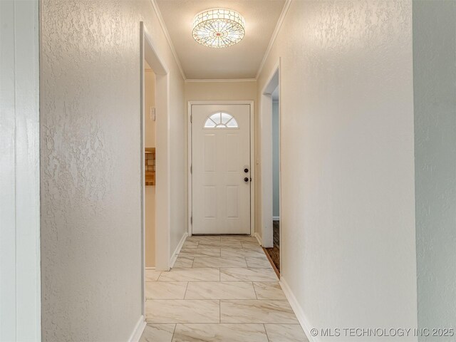 doorway featuring light marble finish floors, crown molding, baseboards, and a textured wall