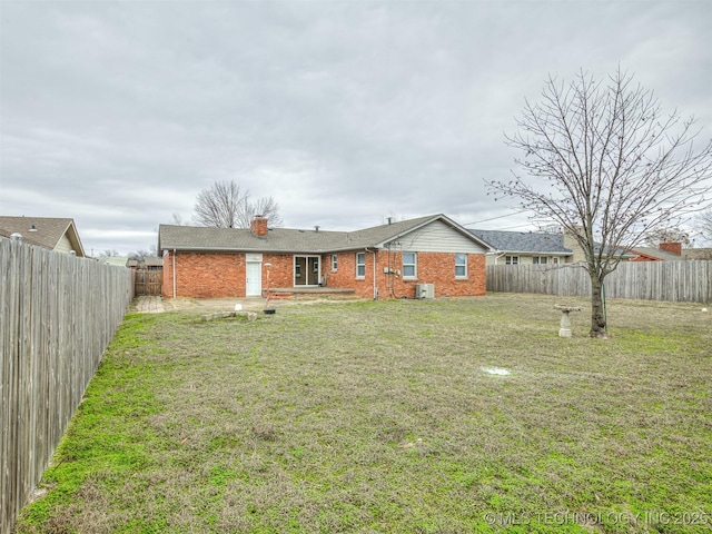 back of property featuring brick siding, a chimney, and central air condition unit