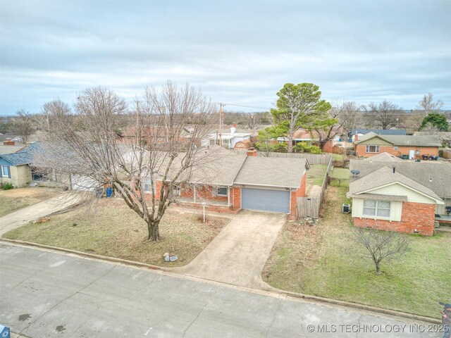 view of front of property with concrete driveway, a residential view, an attached garage, and brick siding