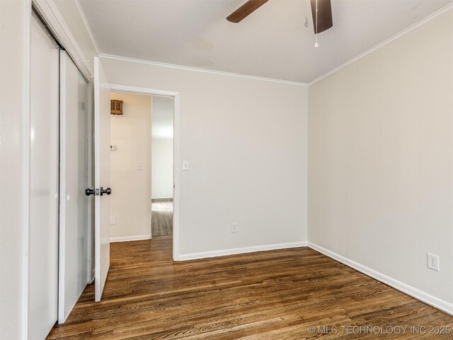 unfurnished bedroom featuring wood finished floors, ornamental molding, a closet, baseboards, and ceiling fan