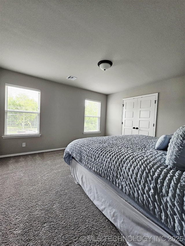 2721 S 8th St E, Broken Arrow, OK 74012 - carpeted bedroom with baseboards and a textured ceiling