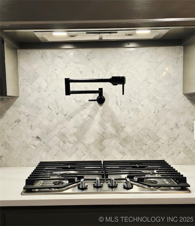 2721 S 8th St E, Broken Arrow, OK 74012 - kitchen view of pot filler, backsplash, light countertops, and stainless steel gas cooktop