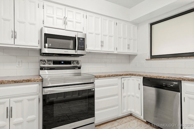 3719 E 84th St, Tulsa, OK 74137 - kitchen with appliances with stainless steel finishes, white cabinetry, and tasteful backsplash