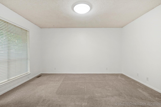 3719 E 84th St, Tulsa, OK 74137 - unfurnished room featuring carpet, baseboards, and a textured ceiling