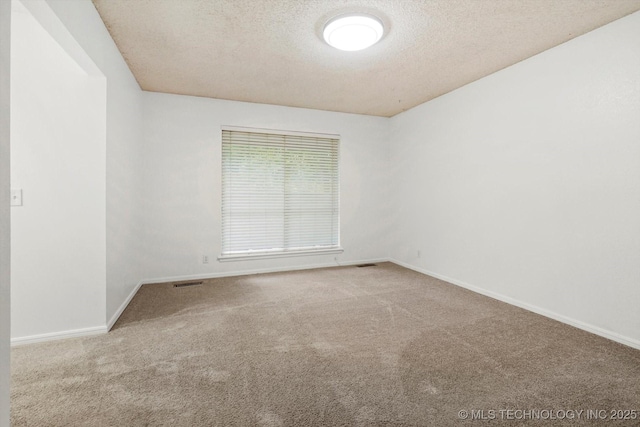 3719 E 84th St, Tulsa, OK 74137 - carpeted spare room featuring baseboards and a textured ceiling
