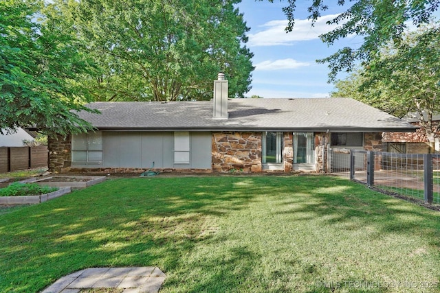 3719 E 84th St, Tulsa, OK 74137 - rear view of house featuring a garden, stone siding, a chimney, and roof with shingles