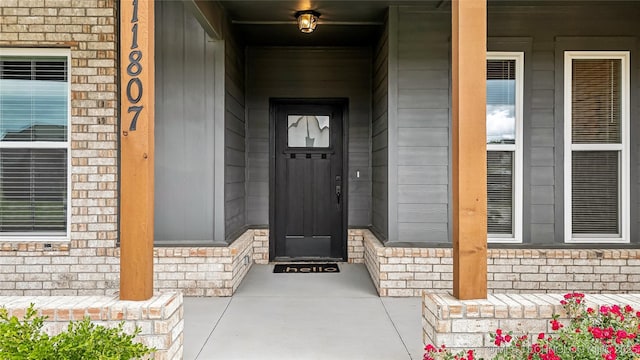 11807 N 131st E Ave, Owasso, OK 74055 - entrance to property with a porch and stone siding