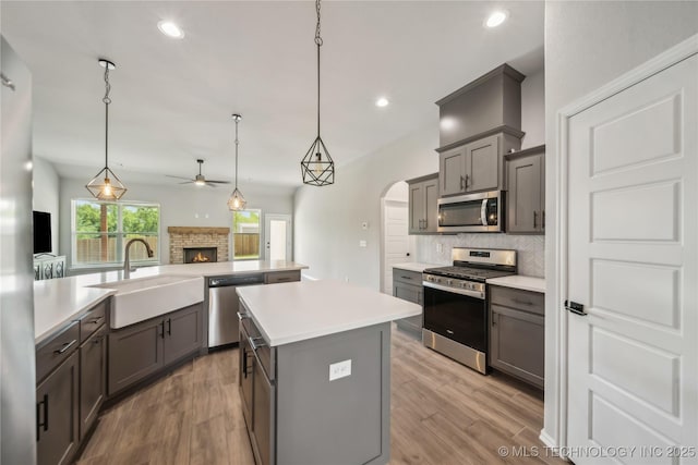 11807 N 131st E Ave, Owasso, OK 74055 - kitchen featuring appliances with stainless steel finishes, a sink, a ceiling fan, a center island, and gray cabinets