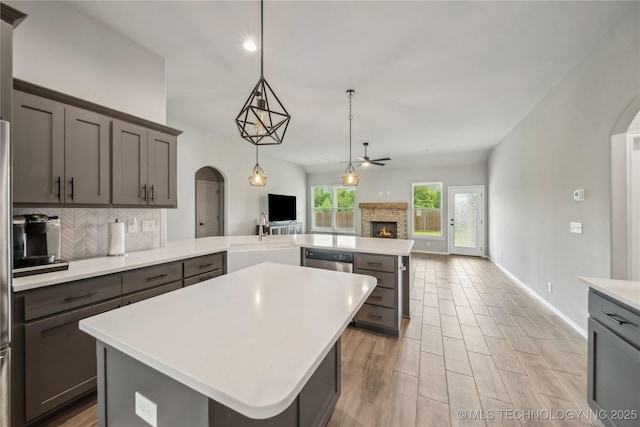 11807 N 131st E Ave, Owasso, OK 74055 - kitchen with a sink, arched walkways, open floor plan, tasteful backsplash, and recessed lighting