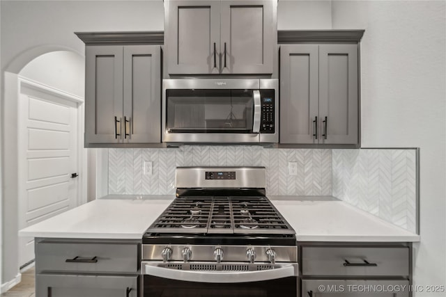 11807 N 131st E Ave, Owasso, OK 74055 - kitchen with appliances with stainless steel finishes, gray cabinets, decorative backsplash, and light countertops