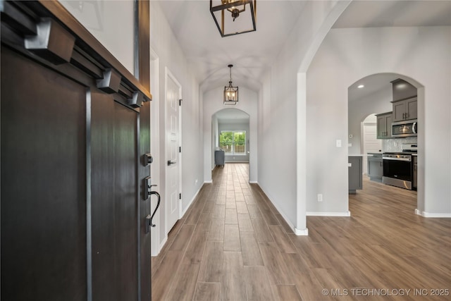 11807 N 131st E Ave, Owasso, OK 74055 - foyer entrance featuring wood finished floors, arched walkways, baseboards, and recessed lighting