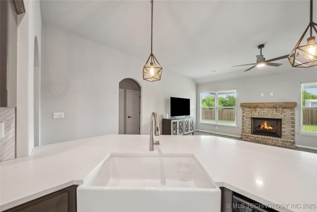 11807 N 131st E Ave, Owasso, OK 74055 - kitchen with a ceiling fan, a sink, healthy amount of natural light, and a fireplace