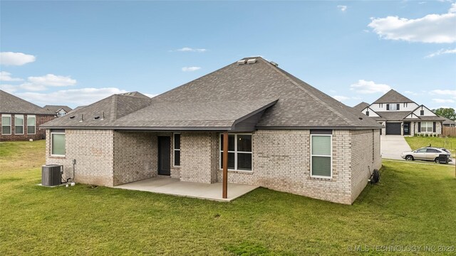 11807 N 131st E Ave, Owasso, OK 74055 - back of house with cooling unit, a yard, a patio, and brick siding