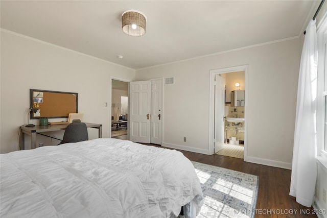 bedroom featuring dark wood-style floors, baseboards, crown molding, and ensuite bathroom