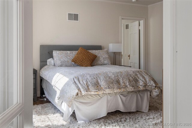 bedroom with ornamental molding
