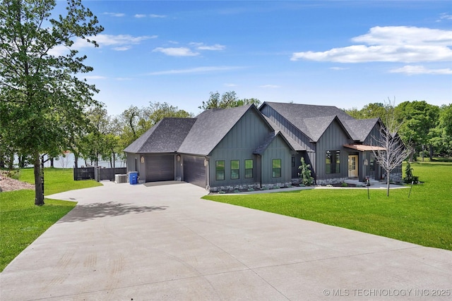 modern farmhouse style home featuring board and batten siding, an attached garage, a front yard, driveway, and roof with shingles