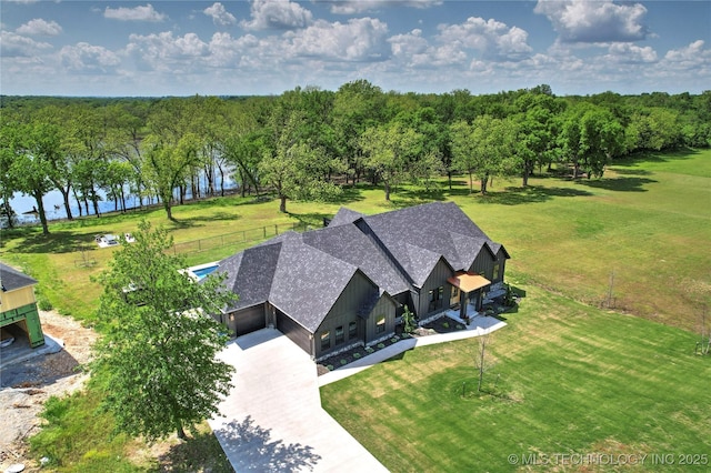 aerial view of property and surrounding area featuring a nearby body of water