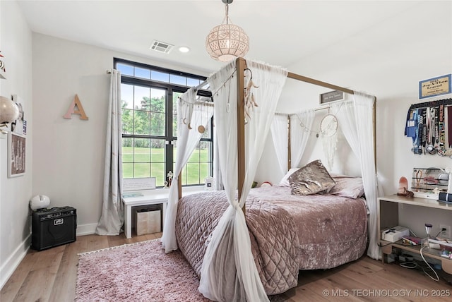 bedroom with wood finished floors and baseboards
