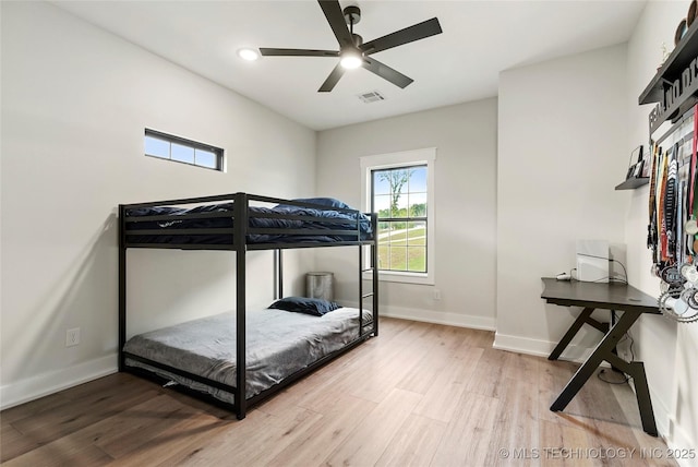 bedroom with wood finished floors, baseboards, and ceiling fan