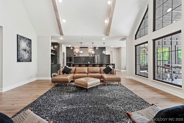 living room featuring light wood-style flooring, baseboards, beamed ceiling, high vaulted ceiling, and recessed lighting