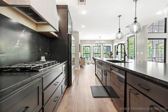 kitchen with dishwasher, a sink, recessed lighting, light wood-style flooring, and gas stovetop