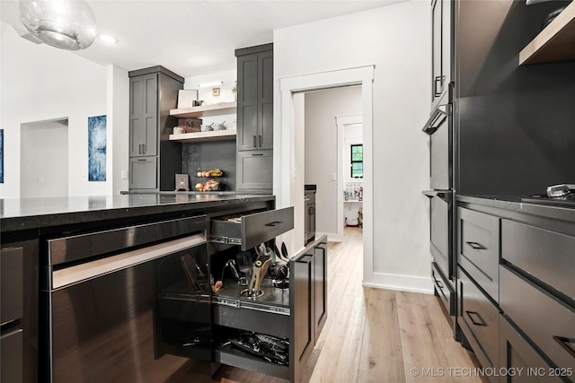 kitchen with light wood-style flooring, open shelves, dark stone counters, recessed lighting, and baseboards