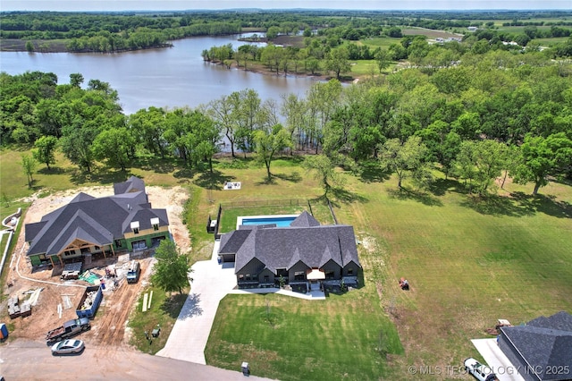 aerial view of property and surrounding area featuring a nearby body of water