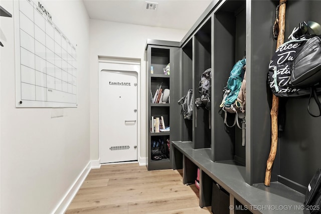 mudroom with light wood finished floors and baseboards