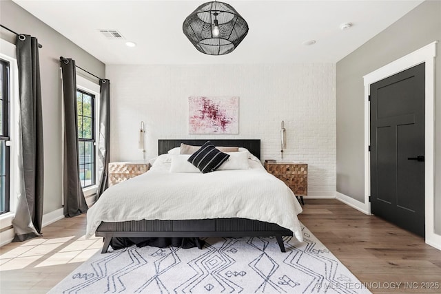 bedroom with light wood-style floors and baseboards