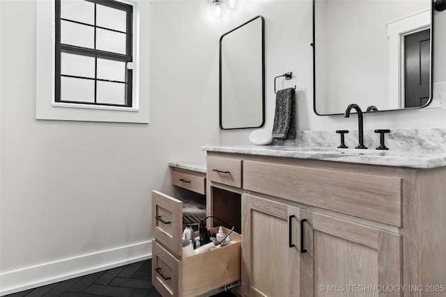 bathroom featuring baseboards and vanity