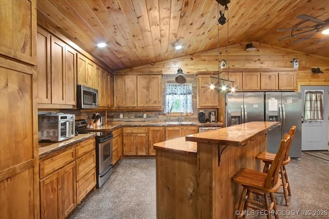 10627 Old Willis, Kingston, OK 73439 - kitchen featuring stainless steel appliances, lofted ceiling, a sink, a kitchen island, and a kitchen breakfast bar