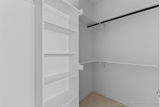 spacious closet with light tile patterned flooring