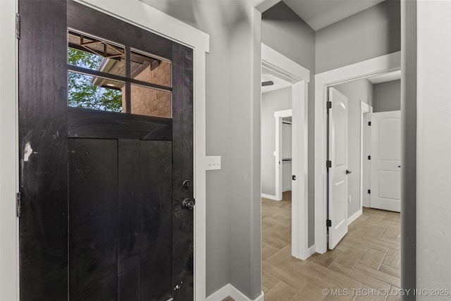 foyer entrance featuring baseboards