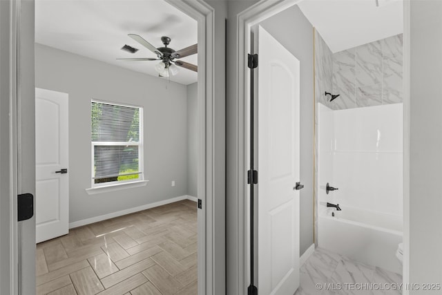 full bath with ceiling fan, baseboards, and shower / washtub combination